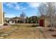 Spacious backyard with large grass area, stone patio, and storage shed at 3392 Homestead Dr, Longmont, CO 80504