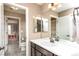 Bathroom with a white vanity, a large mirror, and colorful shower curtain, and tile flooring at 3392 Homestead Dr, Longmont, CO 80504