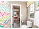Cozy bathroom featuring a colorful chevron shower curtain and views into the adjacent bedroom at 3392 Homestead Dr, Longmont, CO 80504