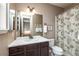 Bathroom with a large mirror, vanity with storage, and a shower/tub with decorative shower curtain at 3392 Homestead Dr, Longmont, CO 80504