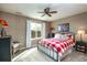 Comfortable bedroom with a large window providing plenty of natural light and a plaid comforter at 3392 Homestead Dr, Longmont, CO 80504