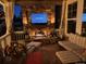 Cozy covered porch with outdoor fireplace, seating, and elegant decor at 3392 Homestead Dr, Longmont, CO 80504