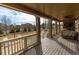 Covered porch with outdoor fireplace, deck, and view of the backyard and neighborhood at 3392 Homestead Dr, Longmont, CO 80504