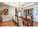 Formal dining area features a chandelier, long table, and built-in cabinet at 3392 Homestead Dr, Longmont, CO 80504