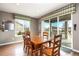 Bright dining room features a wooden table, hardwood floors, and sliding glass doors to the outside deck at 3392 Homestead Dr, Longmont, CO 80504
