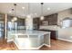 Bright kitchen featuring a granite island, stainless steel appliances and mosaic backsplash at 3392 Homestead Dr, Longmont, CO 80504