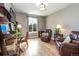 Cozy living room has hardwood floors, large window, comfortable leather chairs, and built-in shelving at 3392 Homestead Dr, Longmont, CO 80504