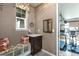 Mud room with built-in bench, cabinet storage, and access to home gym with workout equipment at 3392 Homestead Dr, Longmont, CO 80504