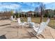 Inviting stone patio with rocking chairs, a small table and firepit at 3392 Homestead Dr, Longmont, CO 80504