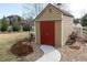 Charming backyard storage shed with red doors and stone pathway in a landscaped yard at 3392 Homestead Dr, Longmont, CO 80504