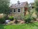 Backyard storage shed with windows surrounded by beautiful landscaping at 3392 Homestead Dr, Longmont, CO 80504