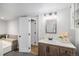 This full bathroom offers a soaking tub, updated vanity, and sleek tile flooring at 2812 W Davies Dr, Littleton, CO 80120
