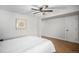 This bedroom features hardwood floors, a ceiling fan, an area for storage, and a neutral color palette at 2812 W Davies Dr, Littleton, CO 80120