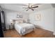 Comfortable bedroom with hardwood floors, a ceiling fan, queen bed and accent lamps at 2812 W Davies Dr, Littleton, CO 80120