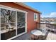 Outdoor living space on the rear deck with seating and a sliding glass door to the interior at 2812 W Davies Dr, Littleton, CO 80120