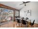 Bright dining area features a glass table, modern chairs, and access to an outdoor deck at 2812 W Davies Dr, Littleton, CO 80120