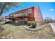 Charming home exterior showcasing a well-maintained lawn, mature trees, and a private balcony at 2812 W Davies Dr, Littleton, CO 80120