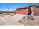 Street view of the townhome featuring a one car garage and rock landscaping at 2812 W Davies Dr, Littleton, CO 80120