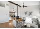 Inviting living room boasts a wood-burning stove and stylish decor, complemented by hardwood floors and a bright dining space at 2812 W Davies Dr, Littleton, CO 80120