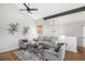 Bright living room featuring hardwood floors, vaulted ceilings, and tasteful decor with a cozy atmosphere at 2812 W Davies Dr, Littleton, CO 80120