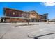 A wide-angle exterior view of the Alamo Drafthouse Cinema with ample parking at 2812 W Davies Dr, Littleton, CO 80120