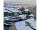 A quiet, snowy neighborhood with mountain views in the background at 2812 W Davies Dr, Littleton, CO 80120