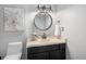 Cozy powder room featuring elegant fixtures, decorative art, and a stylish vanity with great lighting at 2812 W Davies Dr, Littleton, CO 80120