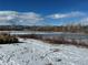 Scenic winter view of a frozen lake with snow-covered banks and mountains in the background at 2812 W Davies Dr, Littleton, CO 80120