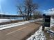 Paved trail next to a snow-covered river with mountain views and bare trees under a blue sky at 2812 W Davies Dr, Littleton, CO 80120