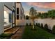 Serene backyard features a modern pathway, lush lawn, tasteful landscaping, and a well-lit tree, creating a peaceful outdoor setting at 203 Garfield St, Denver, CO 80206