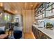 Beautiful home bar area with custom cabinetry, a sleek countertop, floating shelves, and stylish decor at 203 Garfield St, Denver, CO 80206