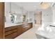 Luxury bathroom with dual vanities, modern fixtures, a soaking tub, and elegant lighting, creating a serene retreat at 203 Garfield St, Denver, CO 80206