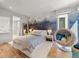 Bright bedroom with mural accent wall, unique hanging chair, and modern furnishings, perfect for relaxation at 203 Garfield St, Denver, CO 80206