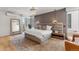 Spacious bedroom with a padded headboard, modern light fixtures, and a large window, creating a luxurious retreat at 203 Garfield St, Denver, CO 80206