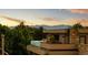 A contemporary building features mountain views and lush greenery, creating a serene backdrop for an outdoor space at 203 Garfield St, Denver, CO 80206