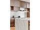 Detailed view of the kitchen featuring a marble backsplash, custom wood cabinetry, and stainless steel appliances at 203 Garfield St, Denver, CO 80206