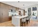 Modern kitchen with a marble waterfall island, wood cabinets, and stainless steel appliances and access to the patio at 203 Garfield St, Denver, CO 80206