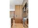A modern kitchen showcasing a wood accent wall, stainless steel appliances, and a marble countertop at 203 Garfield St, Denver, CO 80206