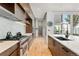 Stylish kitchen featuring stainless steel appliances, island with counter seating, and sleek cabinetry at 203 Garfield St, Denver, CO 80206