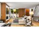Bright living area with wood accents, a modern fireplace, and view into garden at 203 Garfield St, Denver, CO 80206
