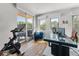 Bright office space with hardwood floors, a Peloton, modern desk, comfortable seating, and access to a private balcony at 203 Garfield St, Denver, CO 80206