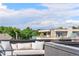 The rooftop deck offers cushioned seating with mountain views and lush surroundings, perfect for relaxation and entertaining at 203 Garfield St, Denver, CO 80206