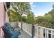 A charming balcony with a seating area offering scenic views of the neighborhood and mature trees at 2721 Curtis St, Denver, CO 80205