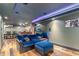 Relax in this finished basement featuring plush seating, exposed brick, and wooden floors at 2721 Curtis St, Denver, CO 80205