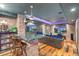 Entertainment basement featuring custom bar with seating, brick wall, and dual televisions at 2721 Curtis St, Denver, CO 80205