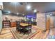 Enjoy the finished basement with a large dining area, exposed brick walls, and custom wooden floors at 2721 Curtis St, Denver, CO 80205