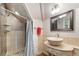 Well-lit bathroom featuring tiled walls, a unique vessel sink, and a modern shower at 2721 Curtis St, Denver, CO 80205