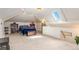 Expansive bedroom with vaulted ceilings, skylight, and cozy carpeting at 2721 Curtis St, Denver, CO 80205