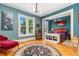 Bedroom area featuring a classic chandelier, large window, and hardwood floors with an open room design at 2721 Curtis St, Denver, CO 80205