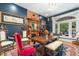 Formal dining room with hardwood floors, detailed trim, brick fireplace and large windows overlooking the front yard at 2721 Curtis St, Denver, CO 80205